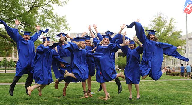 91Ƭ graduates leap in celebration on the Quad